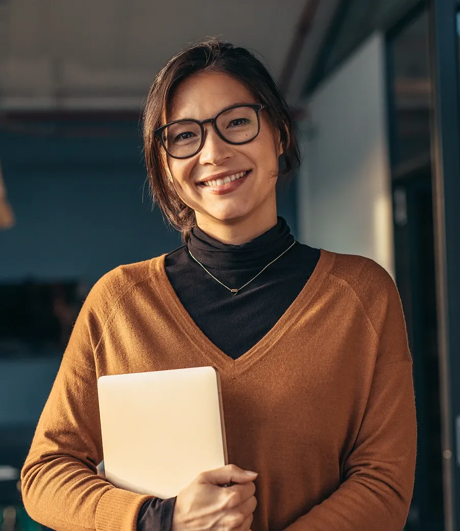 Construction accountant smiling while on a call at her desk